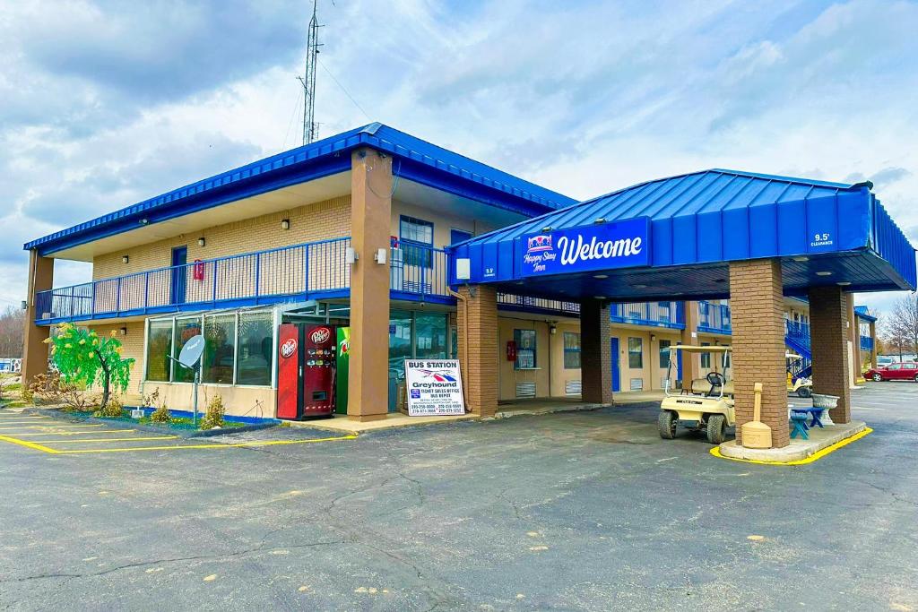 a walmart store with a gas station in a parking lot at Happy Stay Inn Madisonville I-69 By OYO in Madisonville