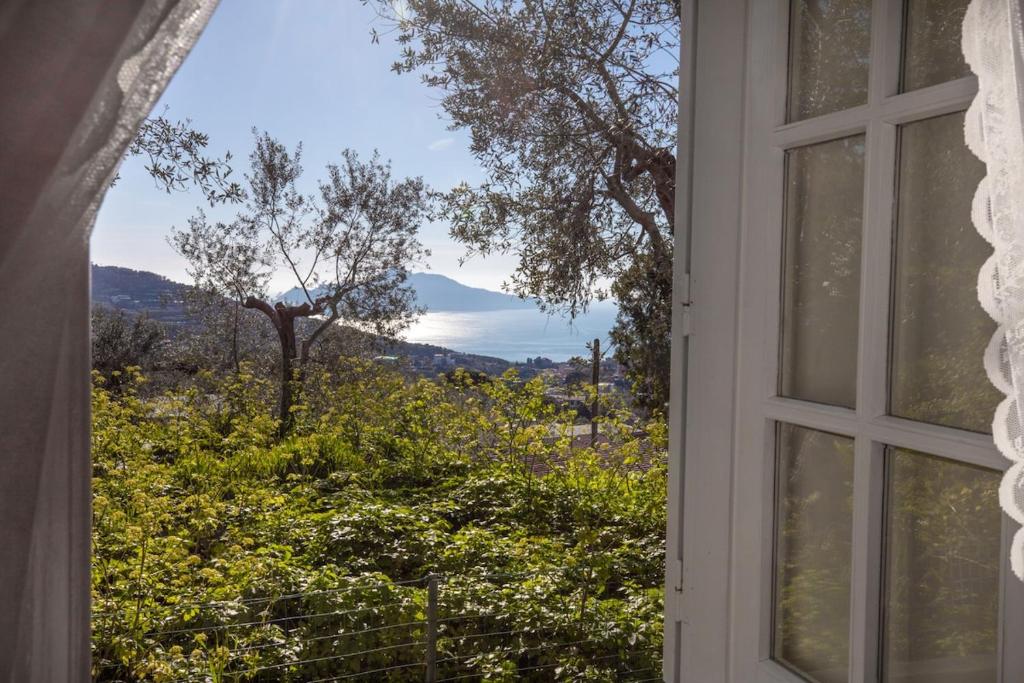 an open window with a view of a mountain at Casale il tramonto in Massa Lubrense