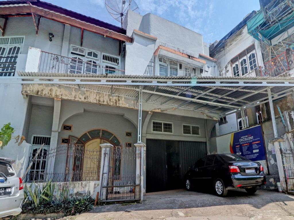 a car parked in front of a building at Hotel O Excellent Kost in Jambi
