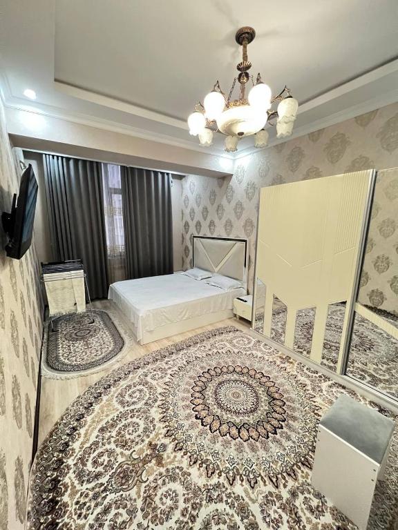 a bedroom with a bed and a chandelier at Apartment 3 in Dushanbe