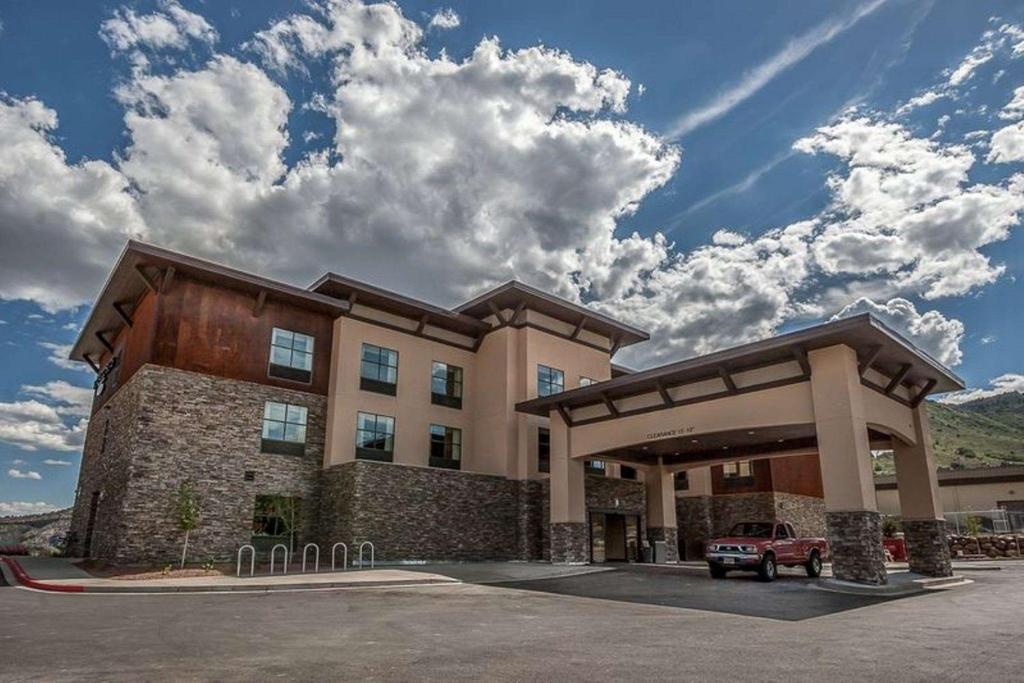 a building with a car parked in front of it at Homewood Suites by Hilton, Durango in Durango