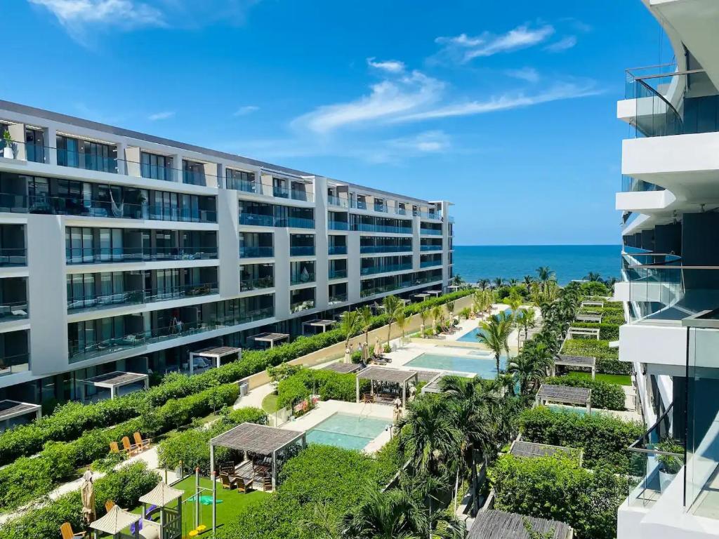 an apartment building with a swimming pool and the ocean at Fantastic Apartment/Beach Front Luxury in Cartagena de Indias