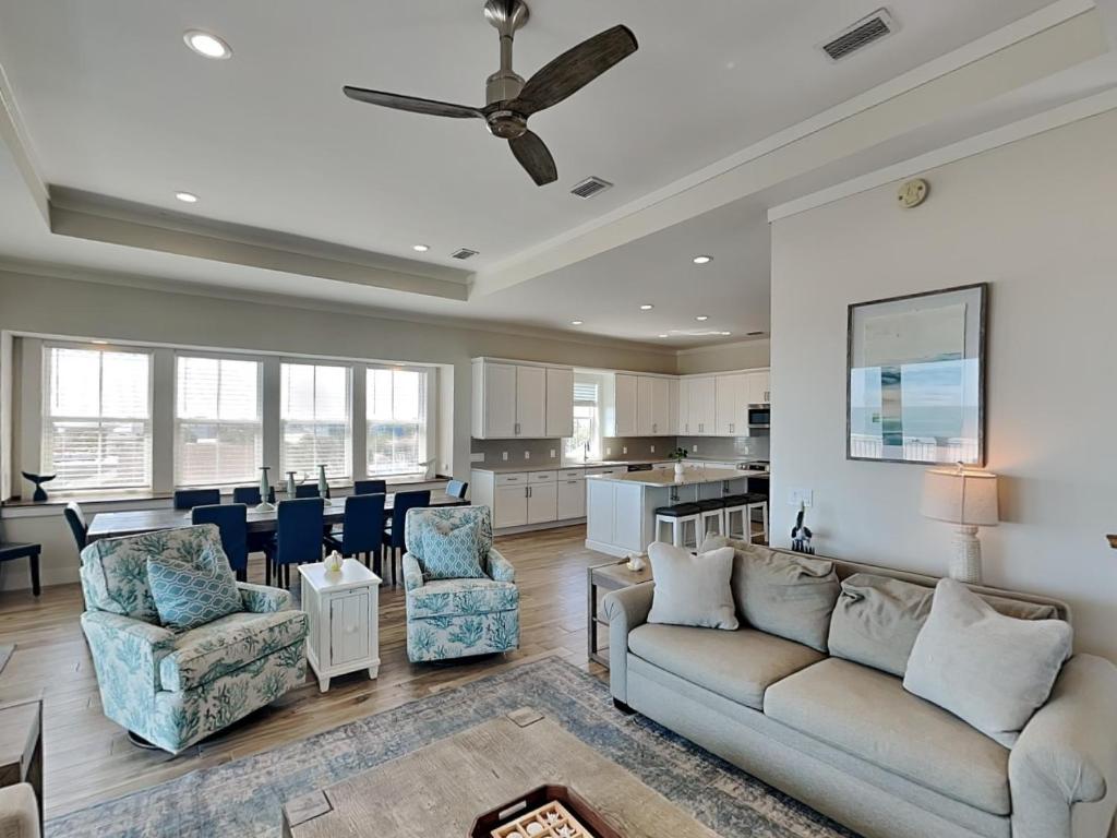 a living room with a couch and chairs and a kitchen at The View in Saint Augustine