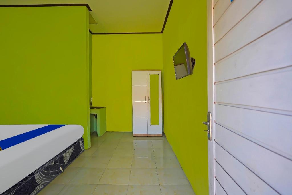 Postel nebo postele na pokoji v ubytování SPOT ON 92669 Guesthouse Prima SyariahNearGPdI Anugerah