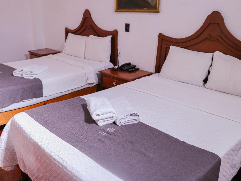 Postel nebo postele na pokoji v ubytování Hotel Frances