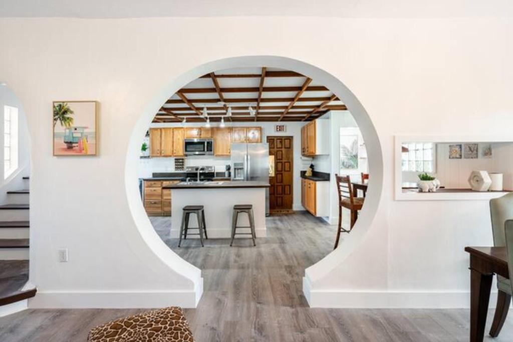an open kitchen and living room with an archway at 10 Minutes from Beach Full House in Hollywood