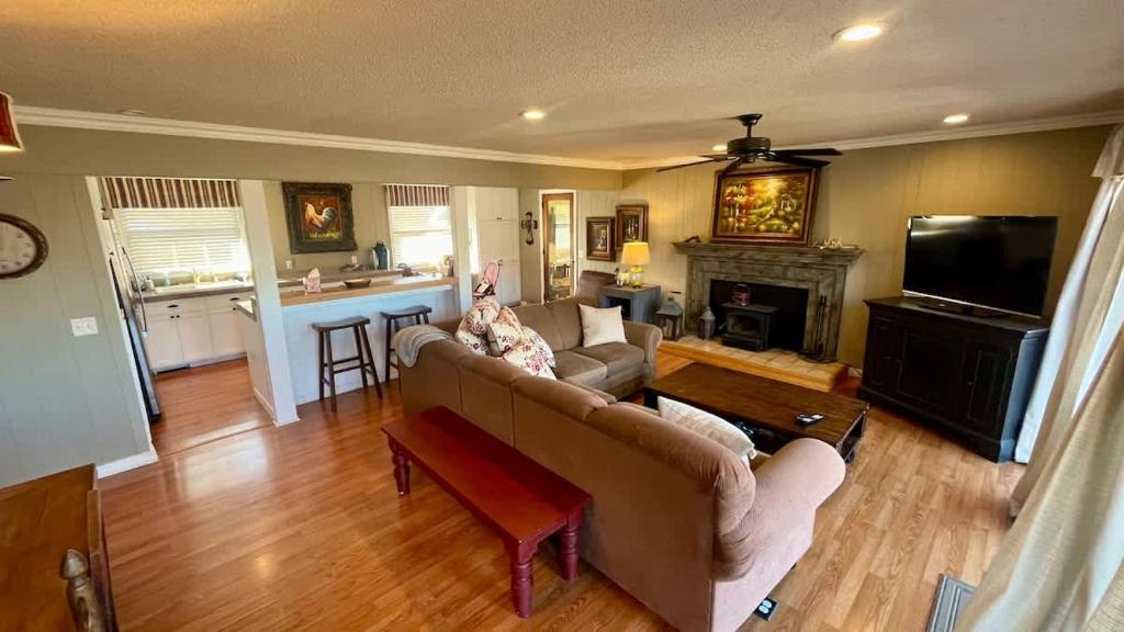 a living room with a couch and a fireplace at Blueberry Bliss Family Retreat on Beaver Lake in Lowell