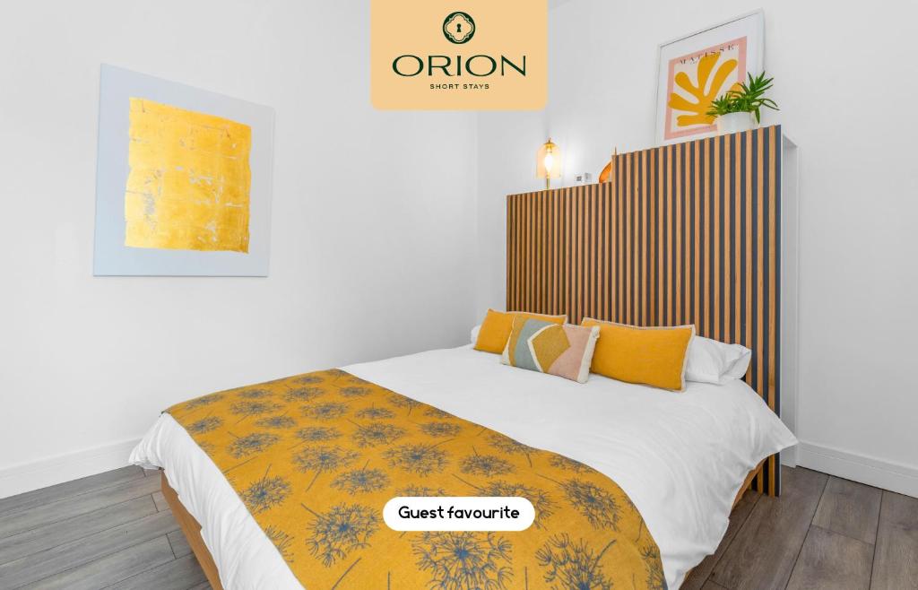 a bedroom with a bed with a yellow blanket at The Kepties 4 - Luxurious Serviced Apartment by ORION SHORT STAYS in Arbroath