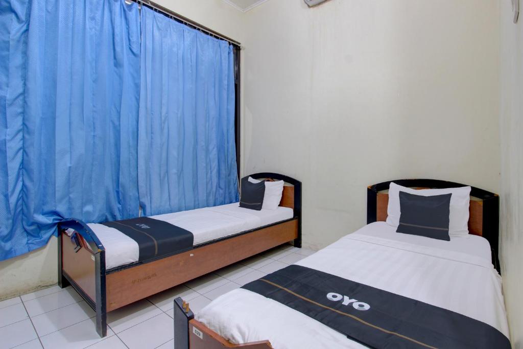 Postel nebo postele na pokoji v ubytování Capital O 93024 Hotel Ganesha