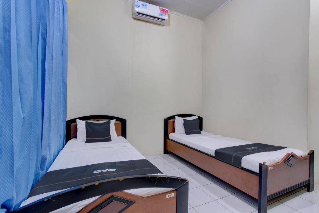Postel nebo postele na pokoji v ubytování Capital O 93024 Hotel Ganesha