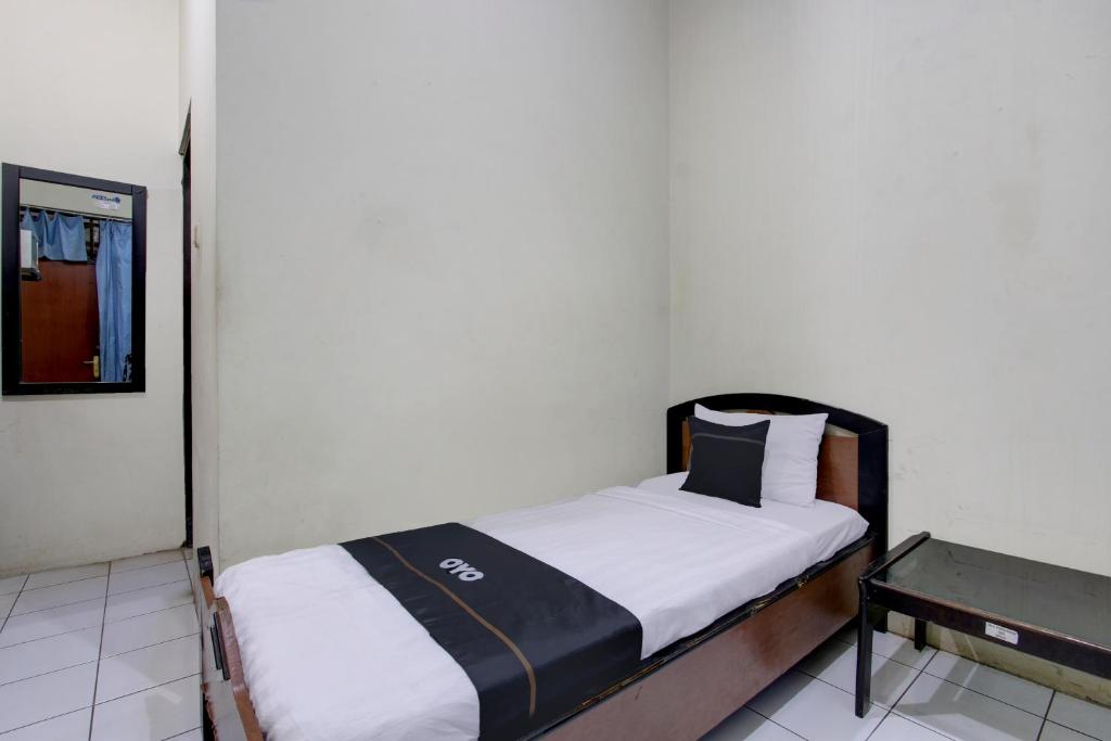Postel nebo postele na pokoji v ubytování Capital O 93024 Hotel Ganesha