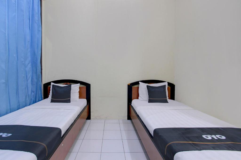 Postel nebo postele na pokoji v ubytování Capital O 93024 Hotel Ganesha