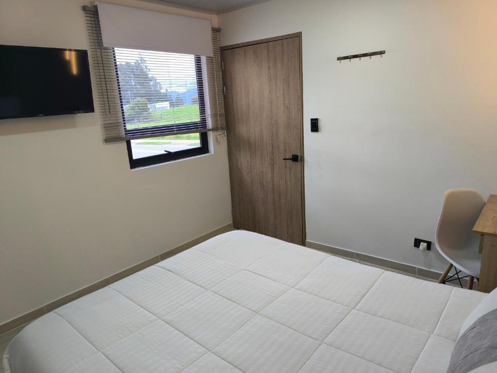 Postel nebo postele na pokoji v ubytování Hotel Cordi