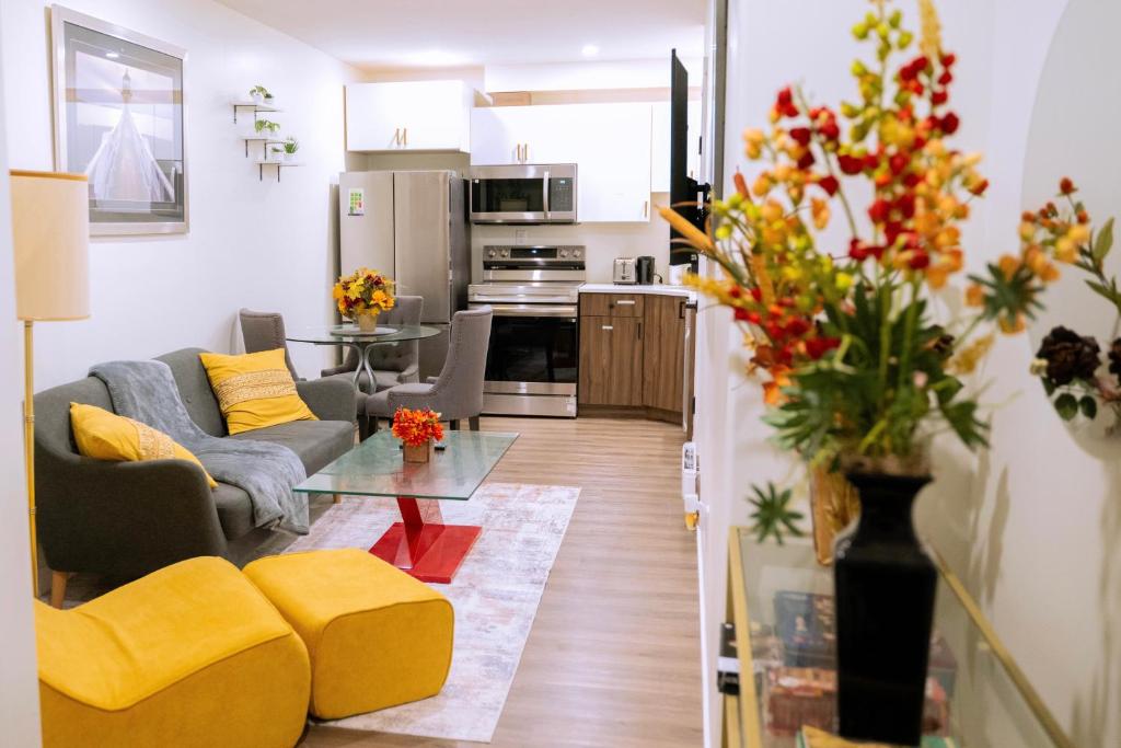 a living room with a couch and a table at Modern and Private Guest Suite in Regina, SK in Regina