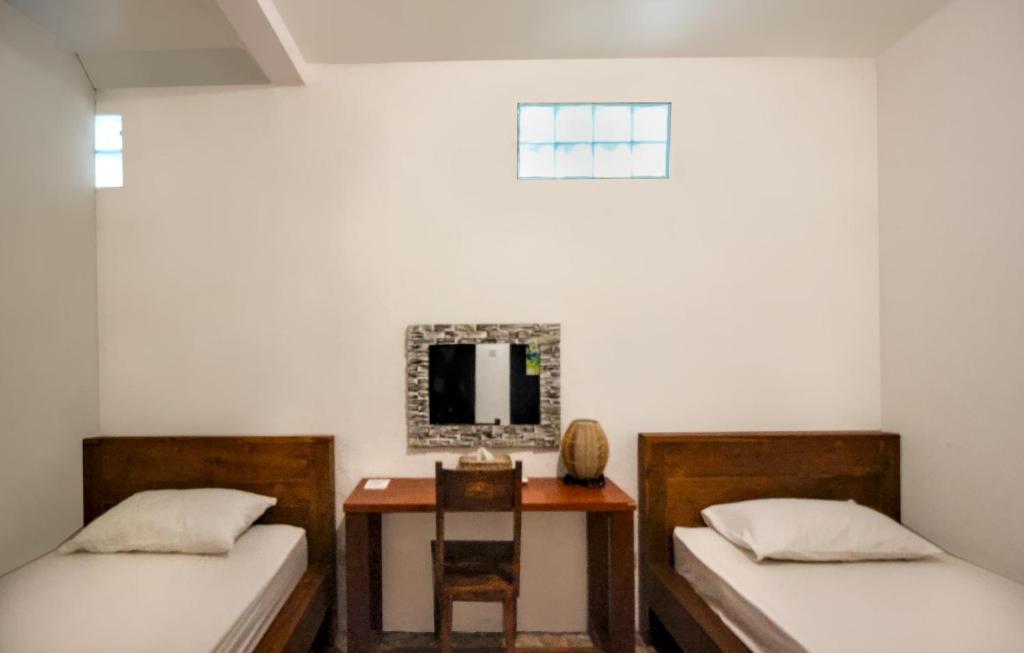 Postel nebo postele na pokoji v ubytování ODA Guest House Ubud