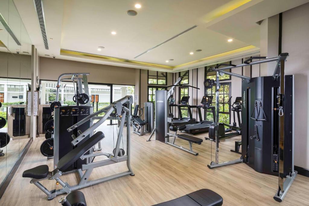 a gym with several tread machines in a room at Banyan Tree Samui in Lamai