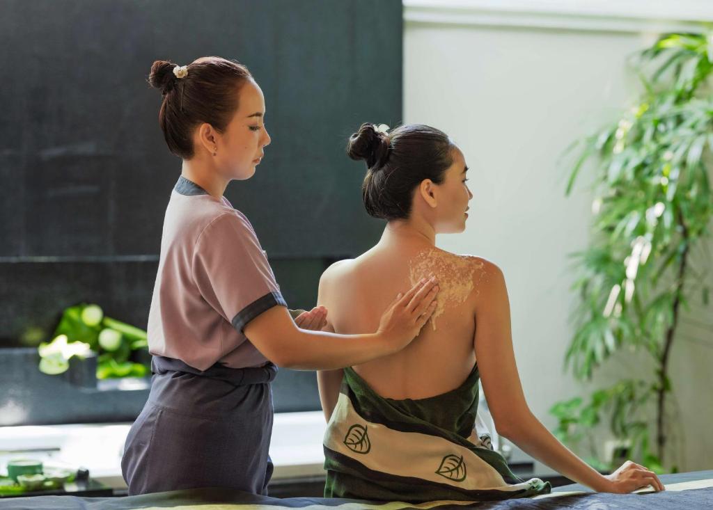 two women are sitting next to each other at Banyan Tree Samui in Lamai
