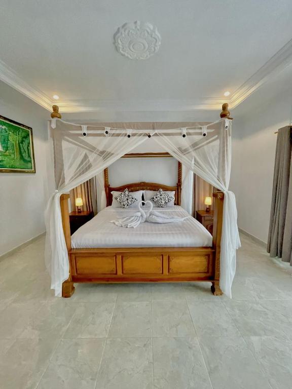 Postel nebo postele na pokoji v ubytování Sekumpul Accommodation