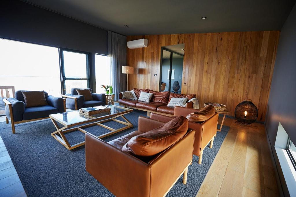 a large living room with couches and a table at King Island Lodge - North & South Lodge in Currie