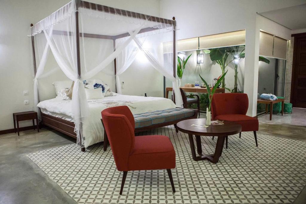 En eller flere senge i et værelse på Coco Presidential Villa & Homestay