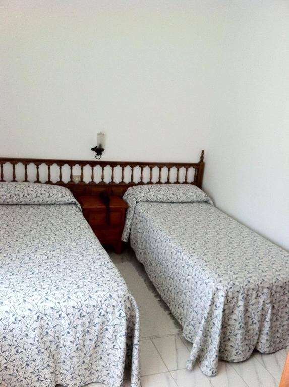 Łóżko lub łóżka w pokoju w obiekcie Hotel Pinzon