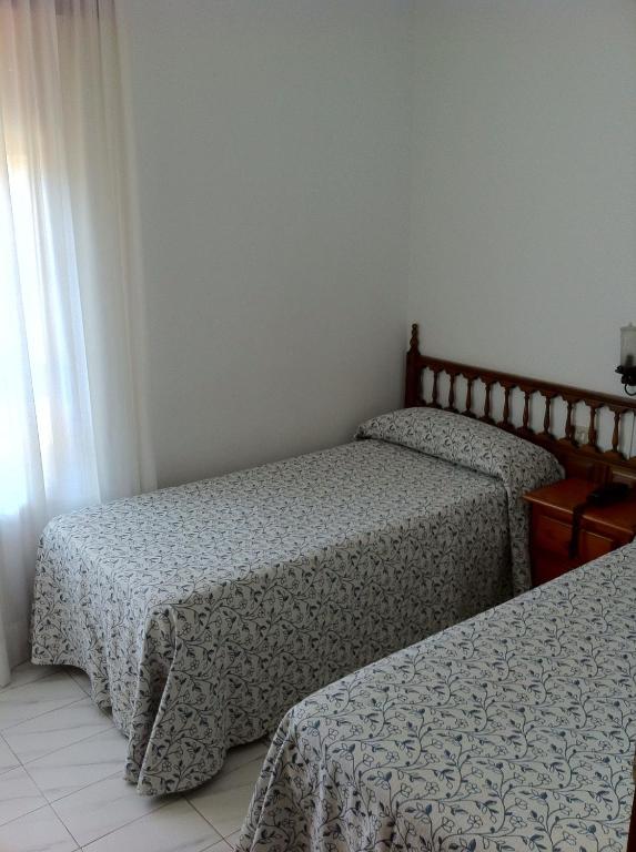 Łóżko lub łóżka w pokoju w obiekcie Hotel Pinzon