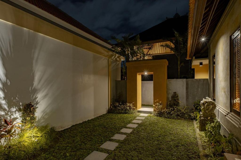 a courtyard of a house at night at Belvilla Prakriti Near Monkey ForestNearCampuhan Ridge Walk in Ubud