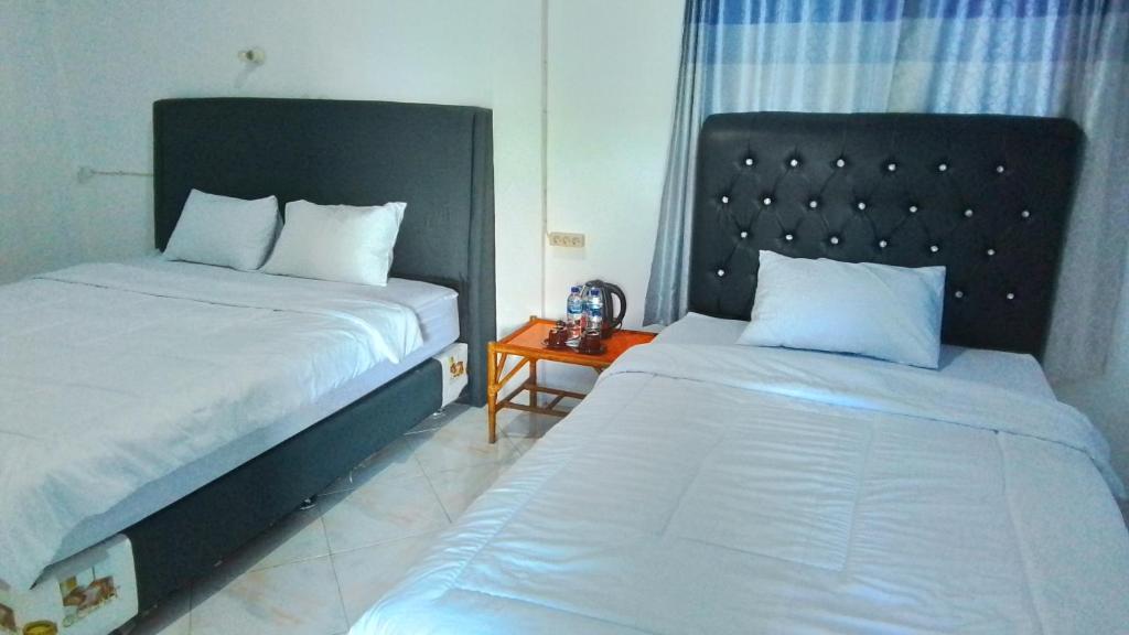 Postel nebo postele na pokoji v ubytování Matraville Home Stay Tuk Tuk Lake Toba Samosir