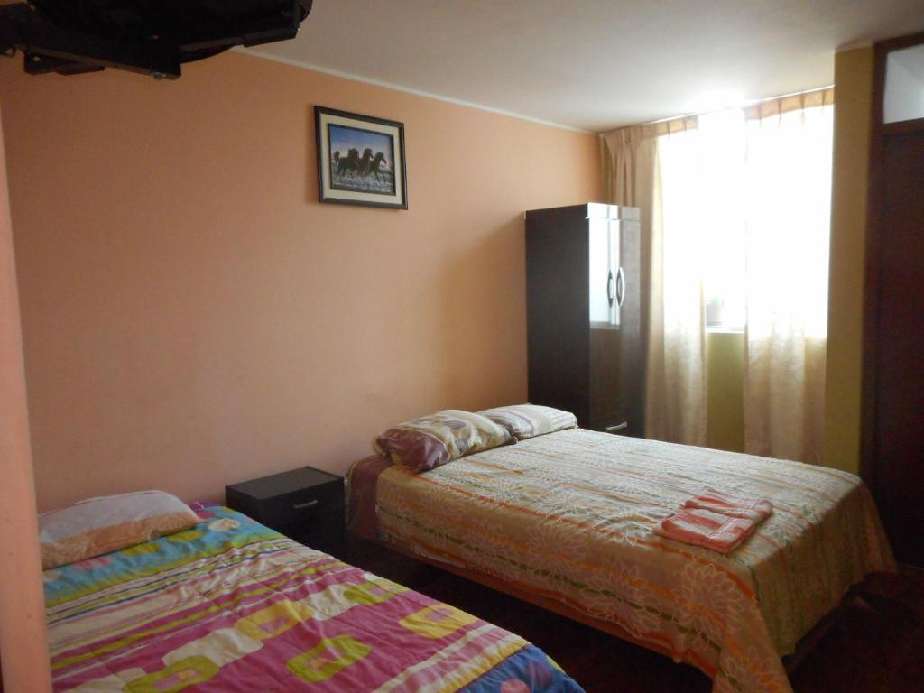 Postel nebo postele na pokoji v ubytování Hostal Geminis