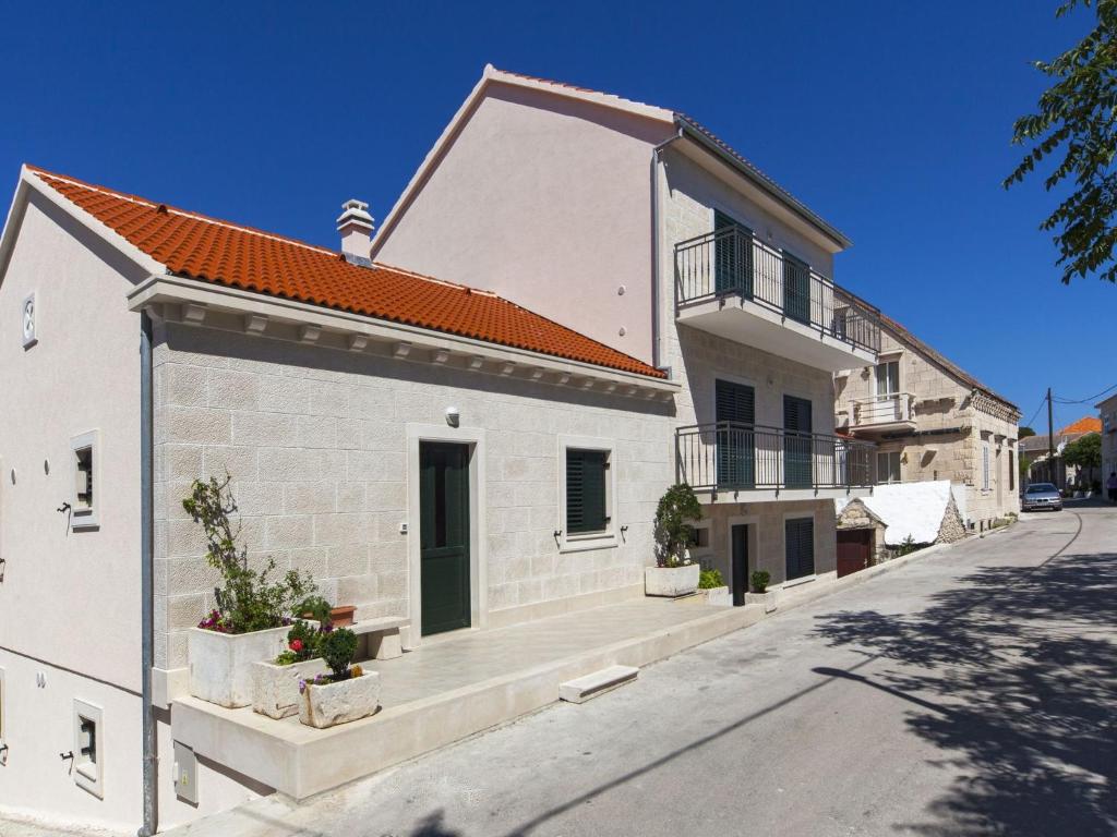 a white brick building with a red roof at Modern Villa in Povlja with Pool in Povlja