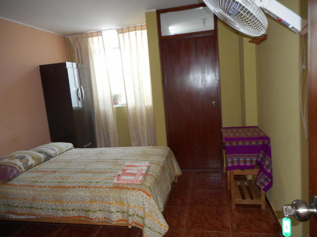 Postel nebo postele na pokoji v ubytování Hostal Geminis