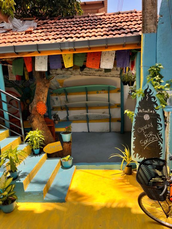 a house with a yellow floor with plants on it at Yoga ShacK in Arugam Bay