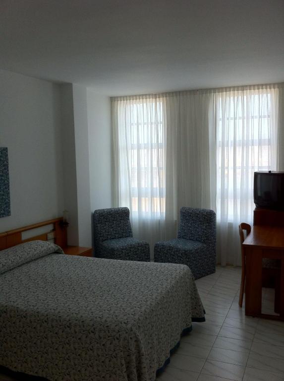 Łóżko lub łóżka w pokoju w obiekcie Hotel Pinzon