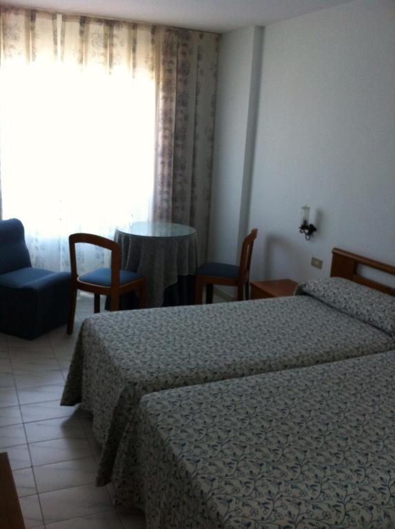 Łóżko lub łóżka w pokoju w obiekcie Hotel Pinzon