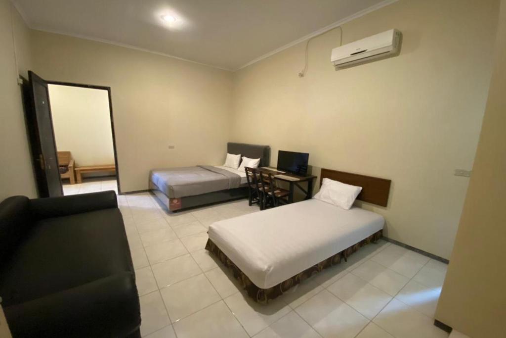 Postel nebo postele na pokoji v ubytování Sweet Home Residence Simpang Lima