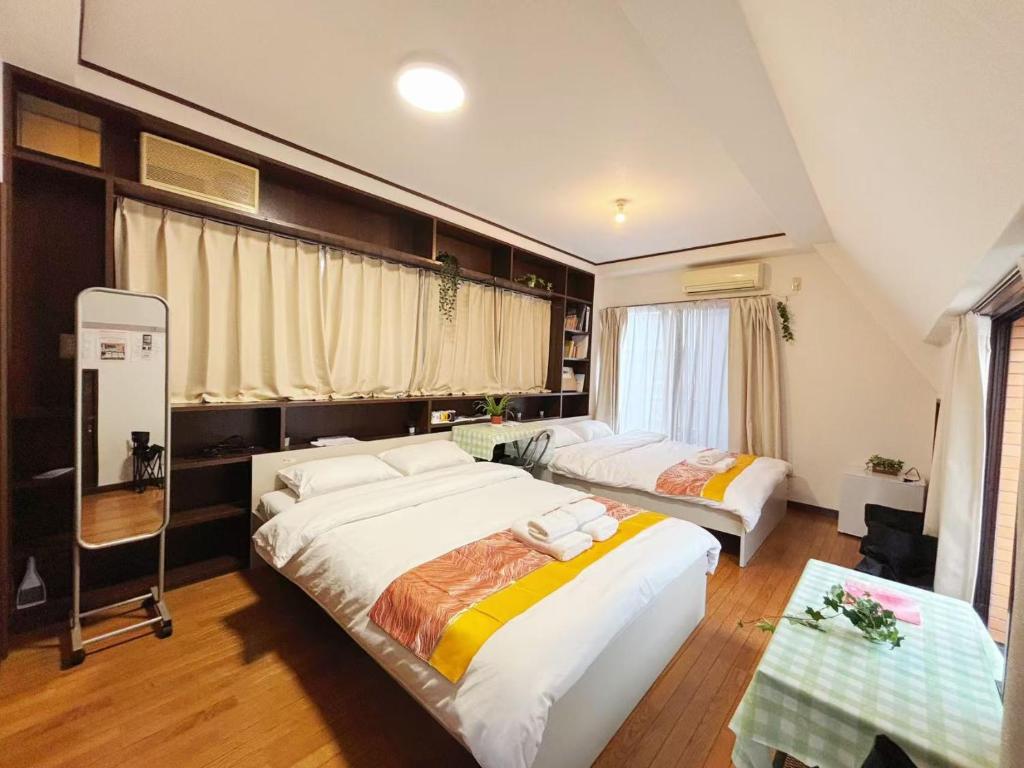 Postel nebo postele na pokoji v ubytování Jl千住別荘