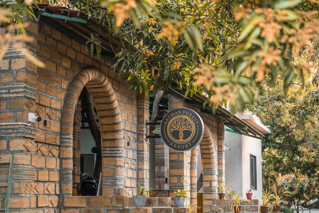a brick building with a sign on it at Aatman Forest Resort - A Luxury Stay in Sasan Gir in Sasan Gir