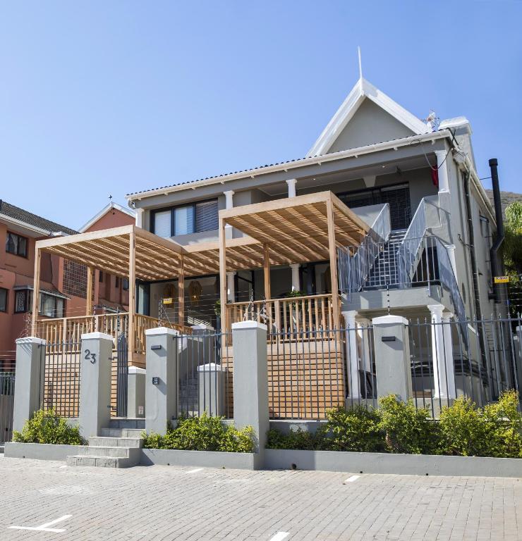 a house with a fence in front of it at Antrim House by Totalstay in Cape Town