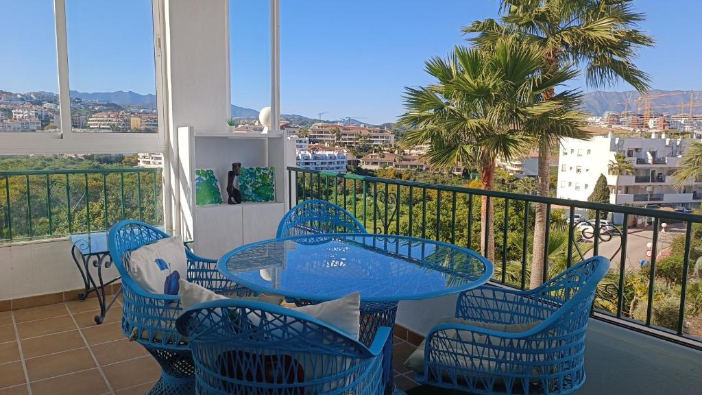 een blauwe tafel en stoelen op een balkon met uitzicht bij La Cala Mijas Cozy Apartment in La Cala de Mijas