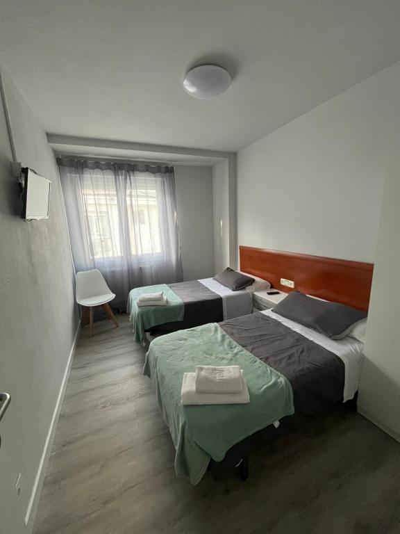 Postel nebo postele na pokoji v ubytování Pensión Luzía - Optional Auto Check-in