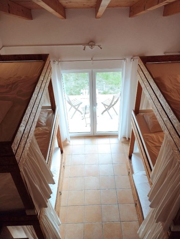 a room with a window and a tiled floor at Endless Summer Surf House in Aljezur