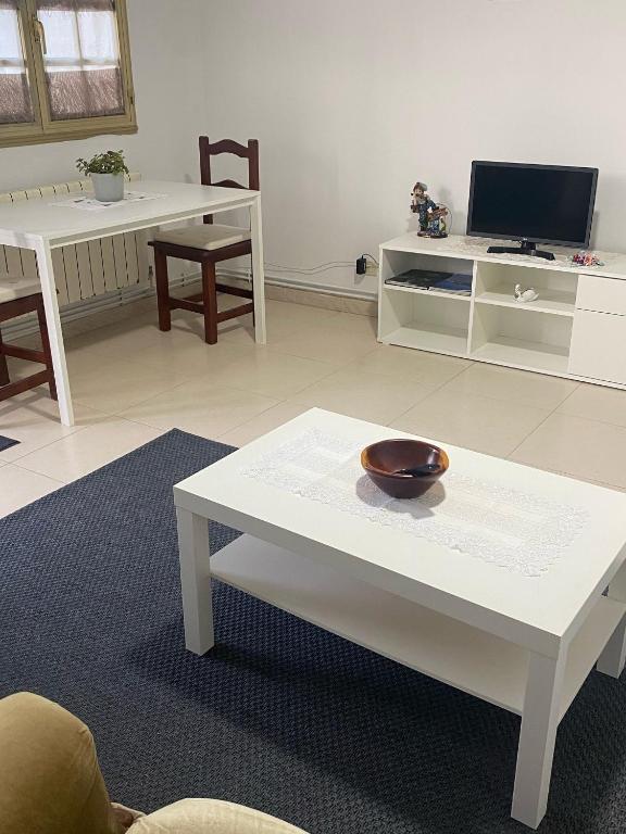 a living room with a white table with a bowl on it at Casa Trasande in Couso