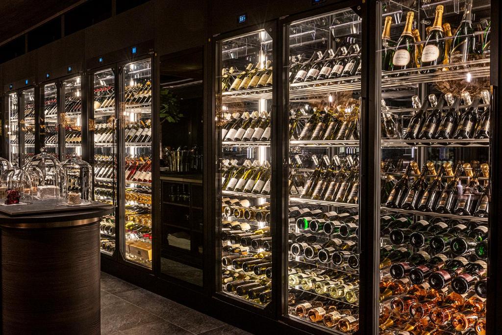 a large display case filled with lots of wine bottles at Anatura Luxembourg in Weiswampach