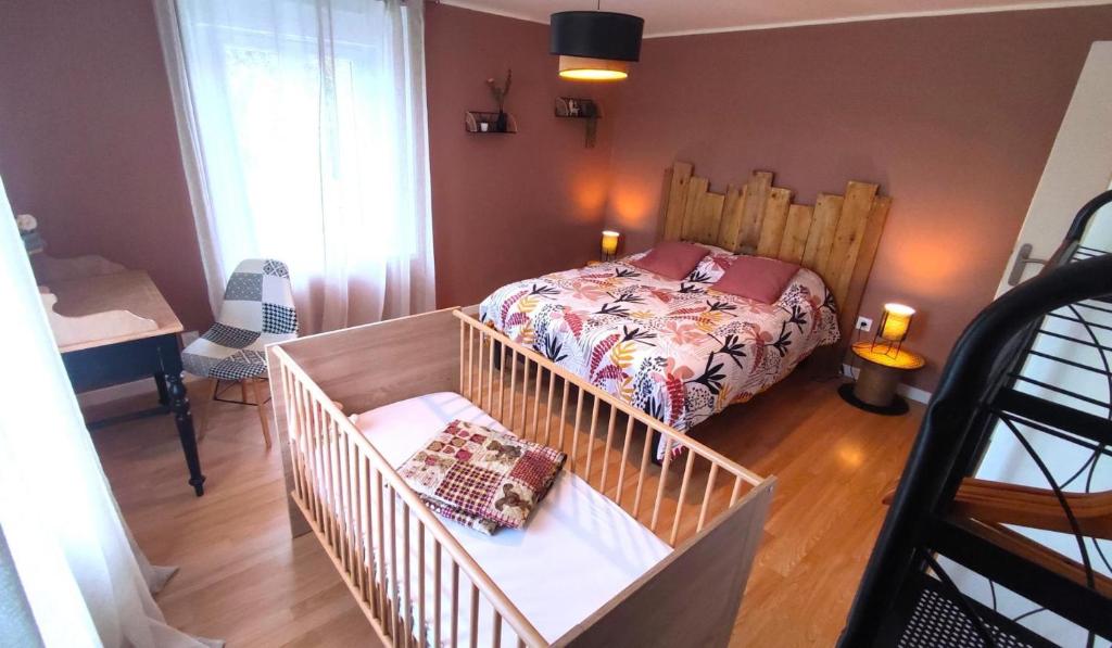 a small bedroom with a bed and a staircase at O naturel in Buzancy