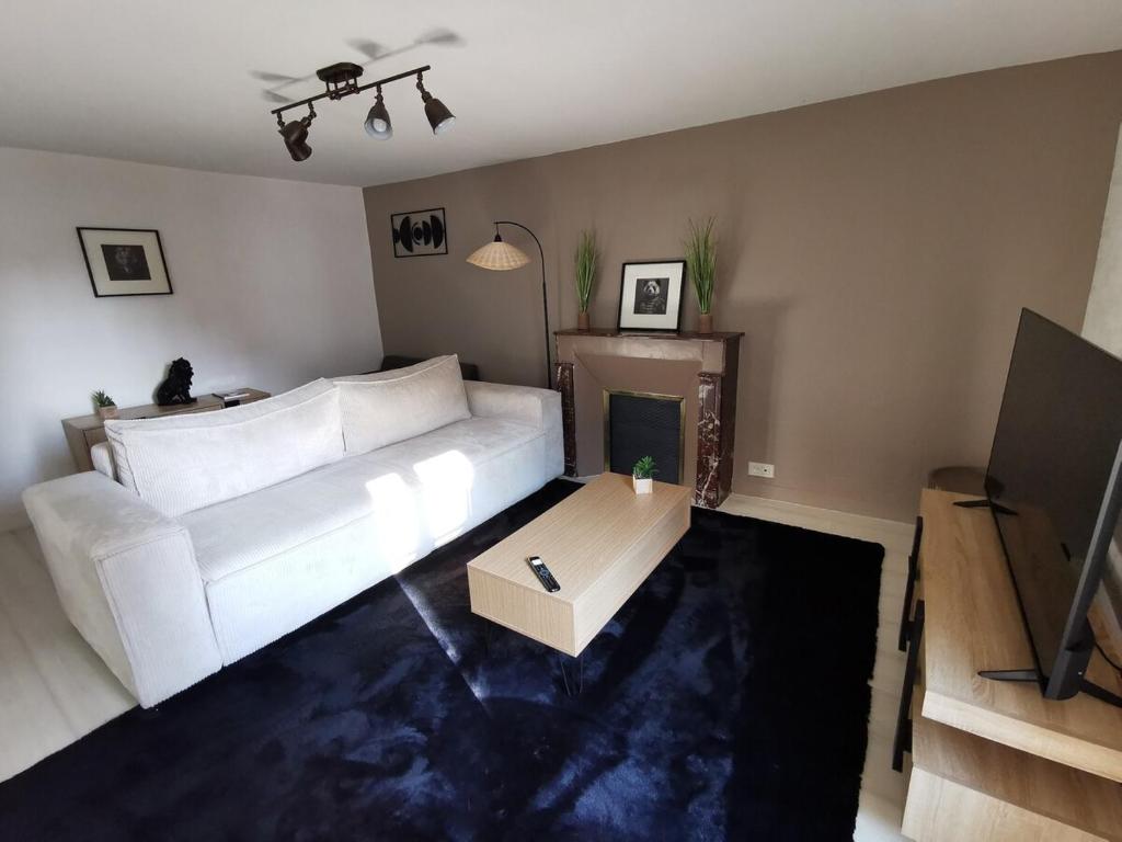 un salon avec un canapé blanc et une table dans l'établissement Ashley, à Concarneau