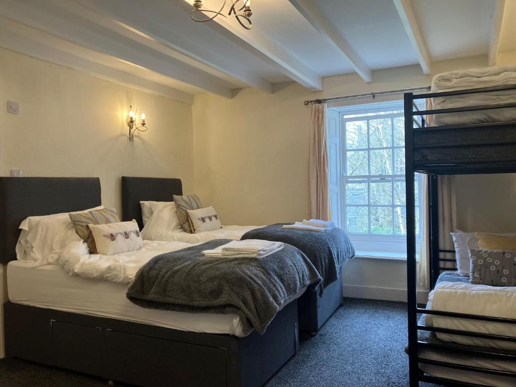 a bedroom with two beds and a bunk bed at Temple Croft Bed and Breakfast in Alston
