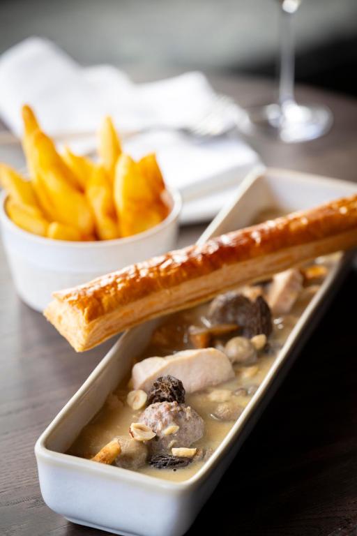 a bowl of soup and a plate of french fries at Anatura Luxembourg in Weiswampach