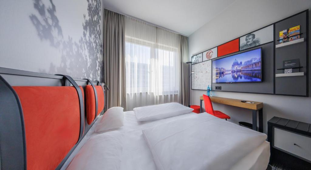 Postel nebo postele na pokoji v ubytování Hotel Lützow