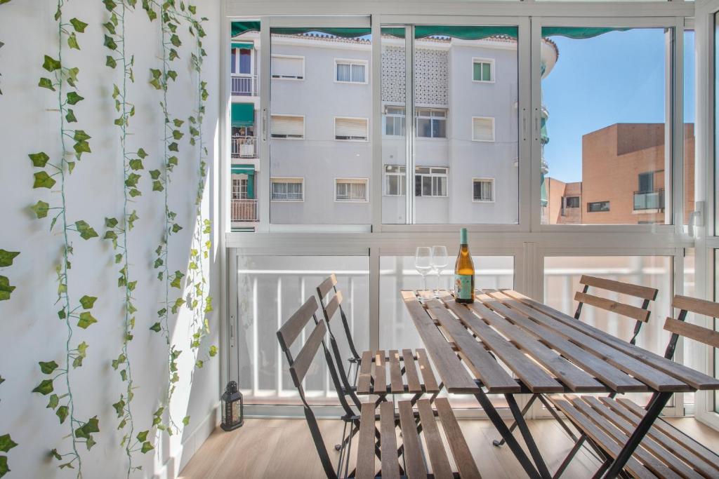 a table and chairs on a balcony with a window at Victoria luxury in Málaga