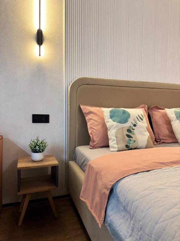 a bedroom with a bed with a nightstand next to it at Квартира 4-36 in Balqash